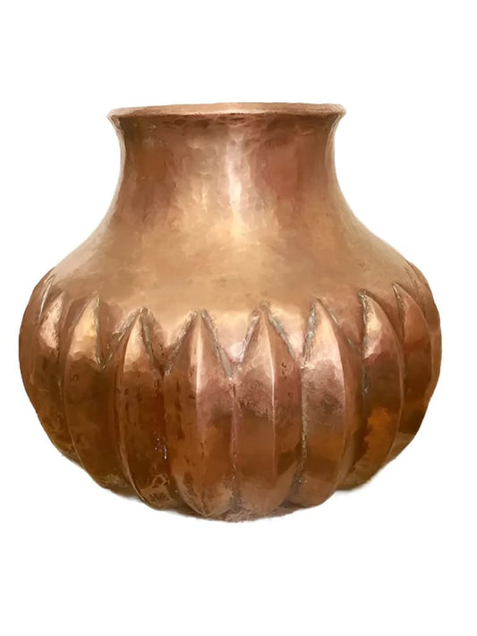 Hammered copper vase with scalloped base.
