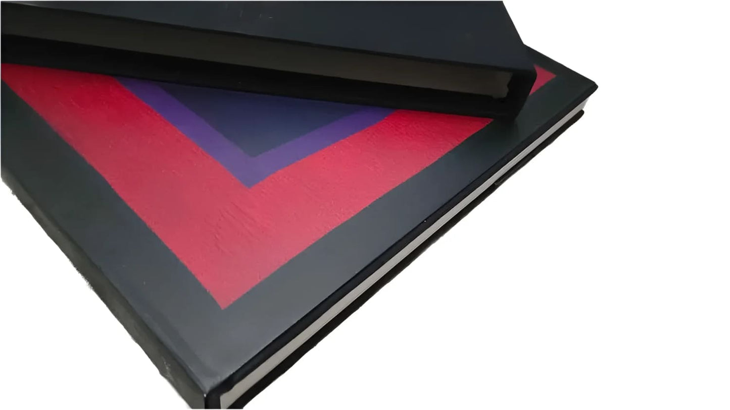 Two dark-colored books, one featuring a red and purple chevron design on its cover.