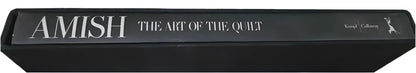 A black book titled ’AMISH THE ART OF THE QUILT’.