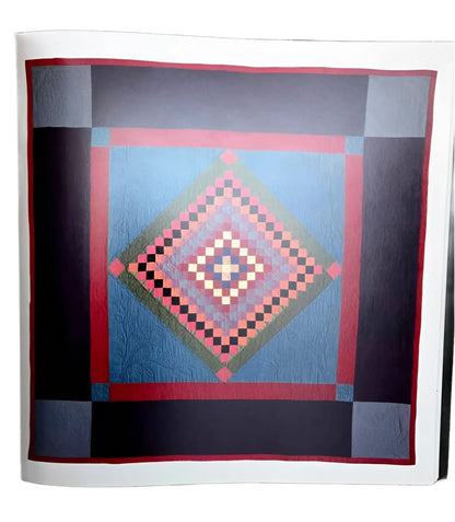 A colorful quilt with a central diamond pattern composed of smaller squares.