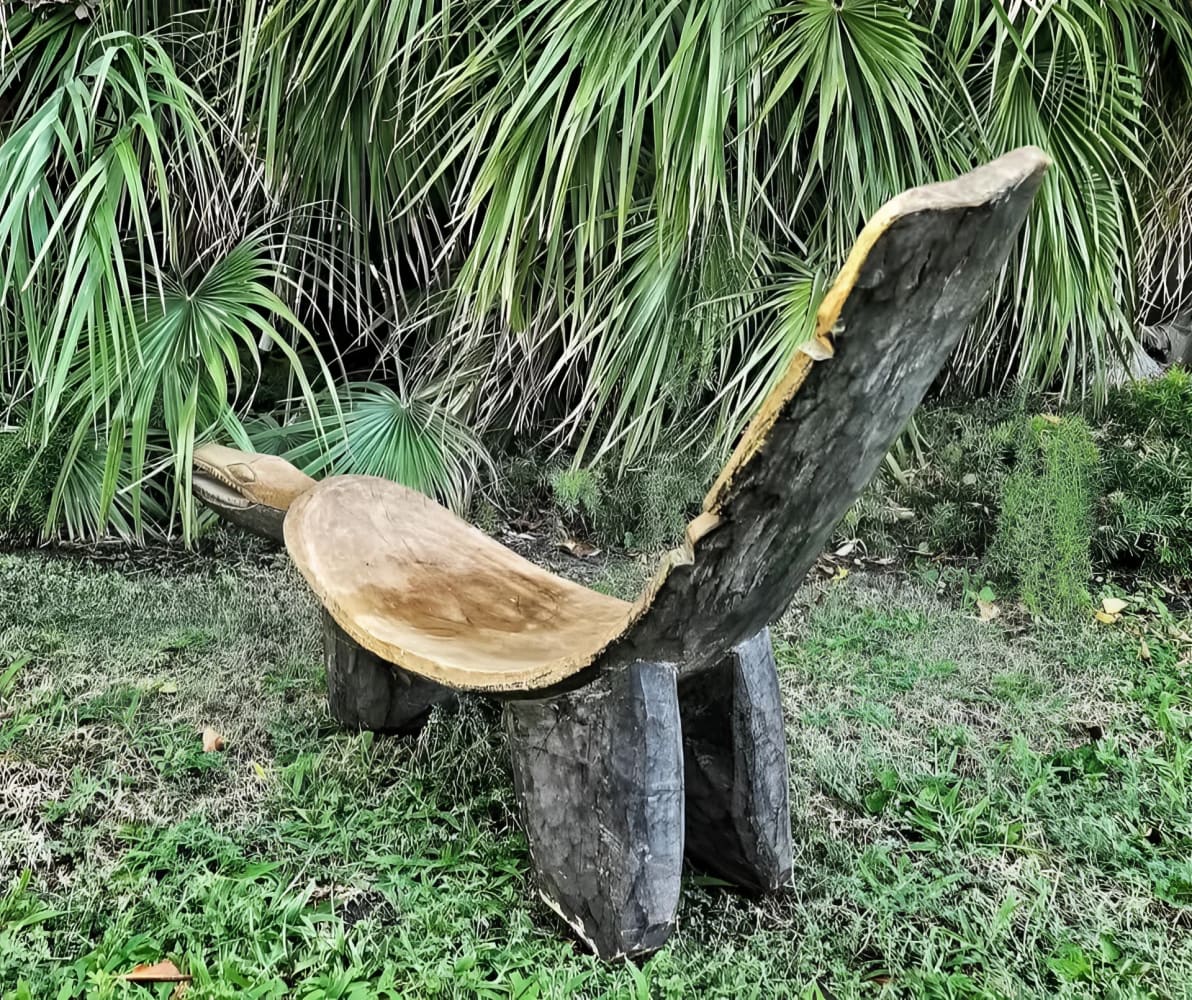 Carved wooden lounge chair.