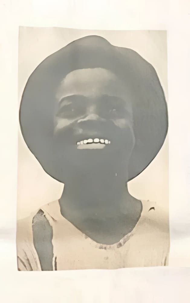 Smiling child in hat.