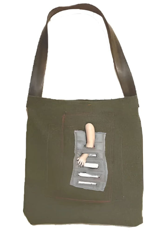Olive green tote bag with doll arm.