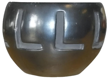Shiny black bowl with letter L designs.