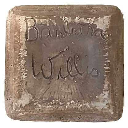 Square, brown, inscribed block.