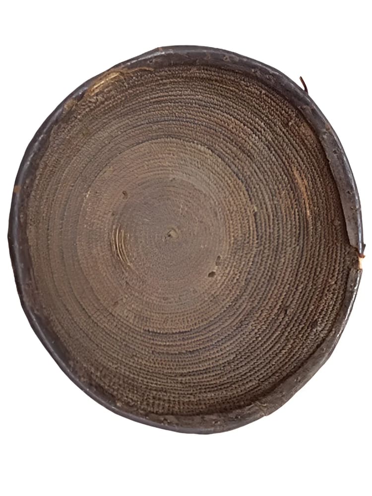 Circular woven tray with dark rim.