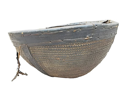 Woven basket with dark rim.