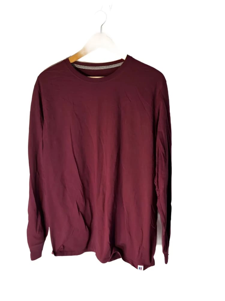 Maroon long-sleeve crewneck shirt on a hanger.