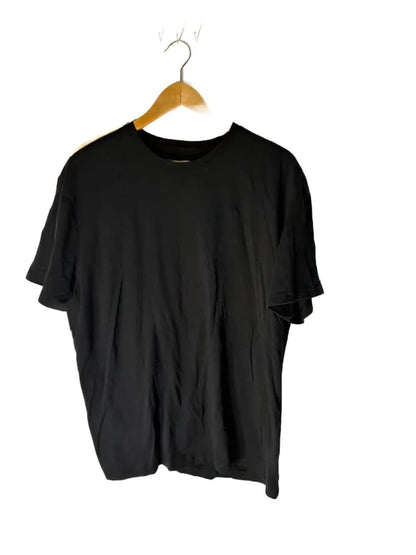 Black short-sleeved t-shirt on a wooden hanger.