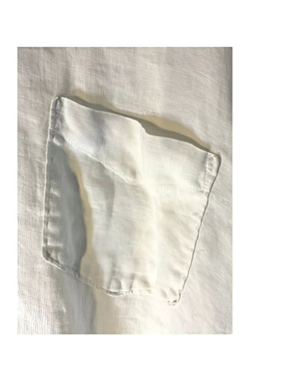 Wrinkled white linen shirt pocket.