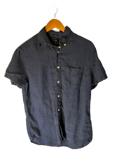 Short-sleeved dark blue button-up shirt with a chest pocket, hanging on a wooden hanger.