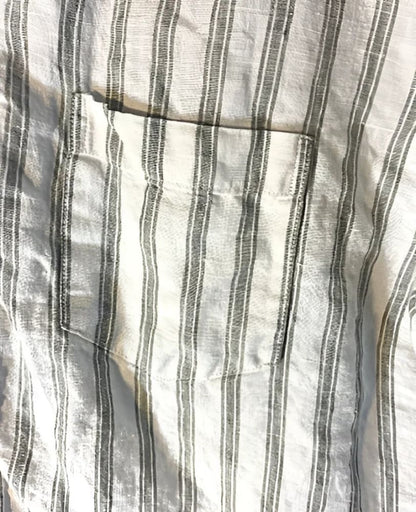 A white and grey striped linen shirt with a chest pocket.