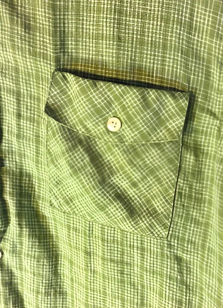 Green plaid shirt with a buttoned pocket.