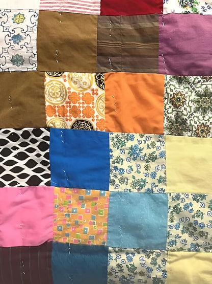 A colorful patchwork quilt made from various fabric squares.