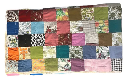 Handmade patchwork quilt with various colorful fabric squares.
