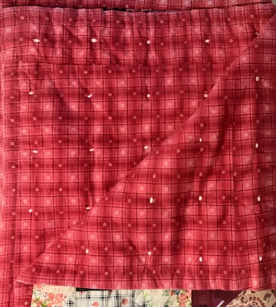 A red plaid fabric with white dots.