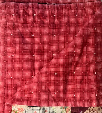 A red plaid fabric with white dots.