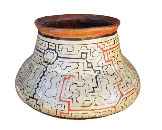 A painted ceramic pot with geometric patterns.