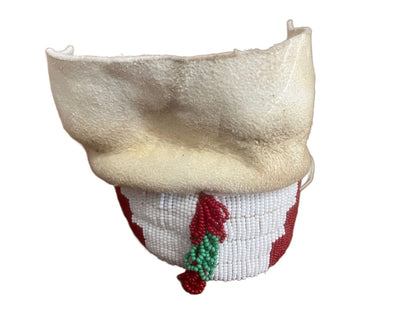 A white deerskin pouch with a beaded lower section featuring red and green accents.