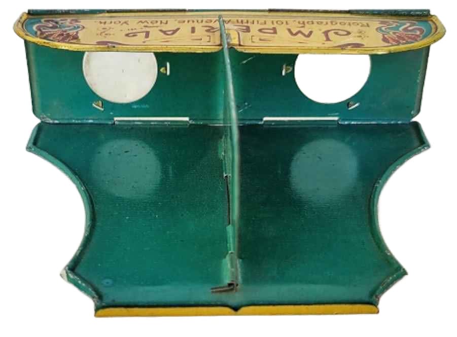 An antique green and gold metal stereoscope viewer.