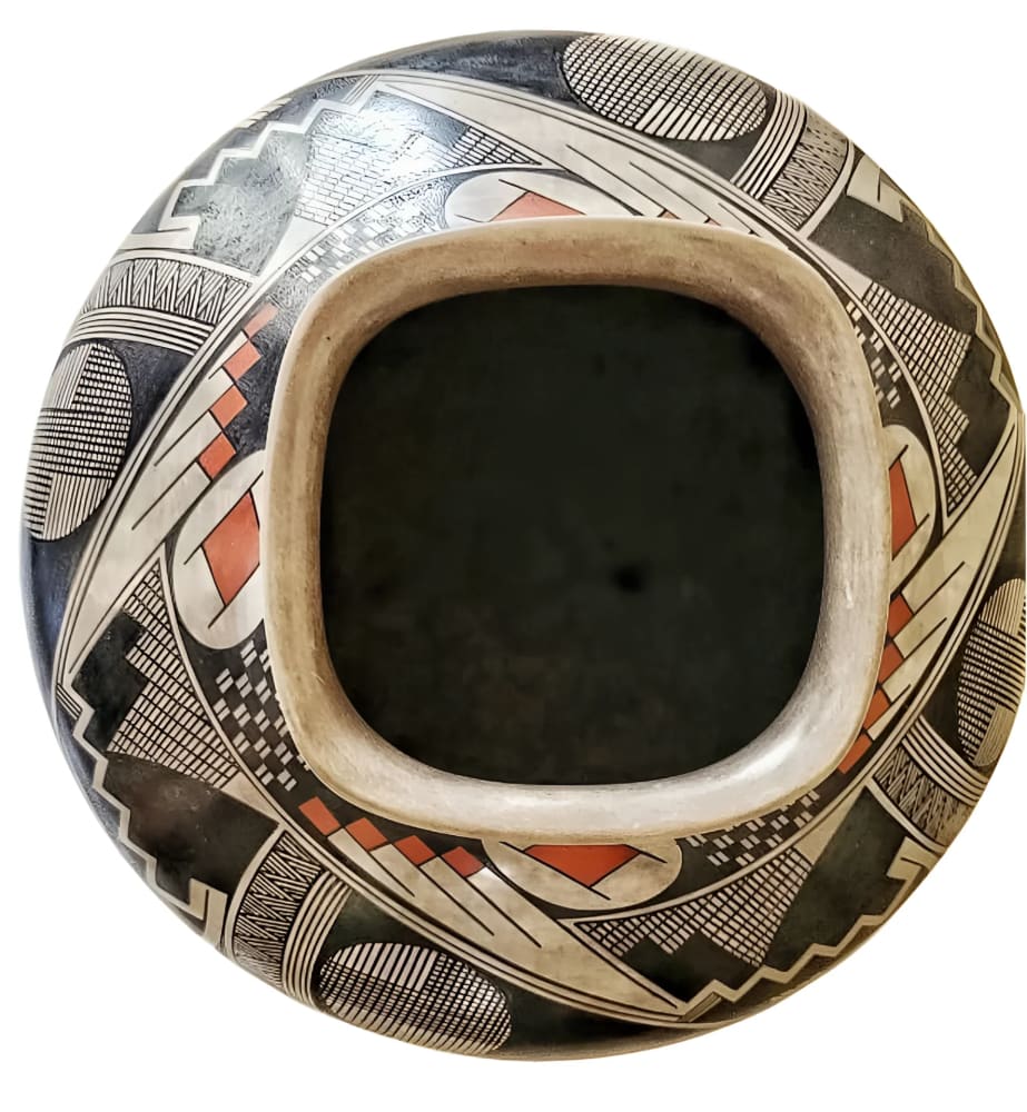Hand-painted Native American pottery bowl with intricate geometric designs and a unique rectangular opening.