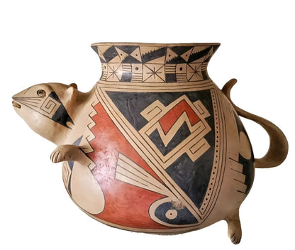 Ornate Southwestern pottery vessel with a stylized animal spout and geometric patterns.