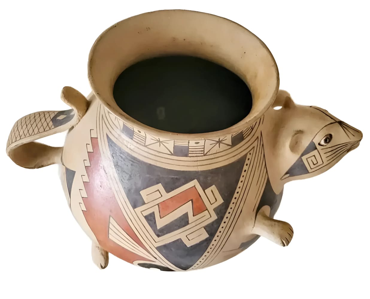 A light-colored pottery vessel with a wide mouth, painted geometric patterns in black, red, and white, and an animal-shaped spout with small legs and a tail handle.