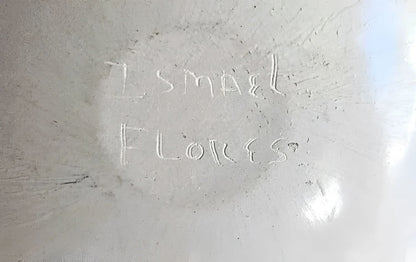 White, textured surface with faint, carved writing.