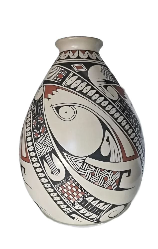 A cream-colored pottery vase with intricate black and reddish-brown geometric patterns.