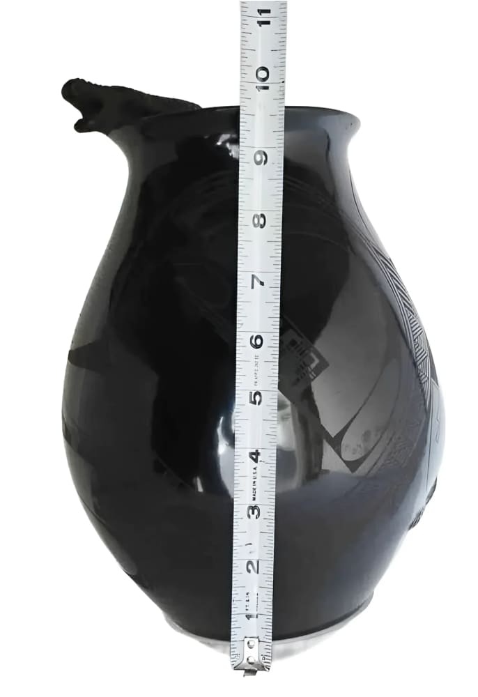 A black, glossy ceramic vase with a sculpted animal head spout and incised decoration, measuring approximately 10.5 inches in height.