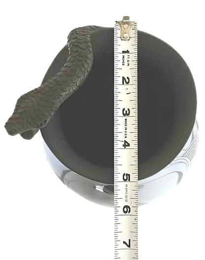 A black ceramic vase with a snake-shaped handle.